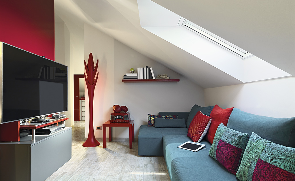 attic with entertainment center and grey/red furniture