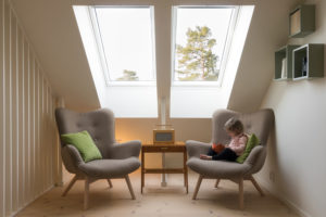 Kid reading book in modern attic
